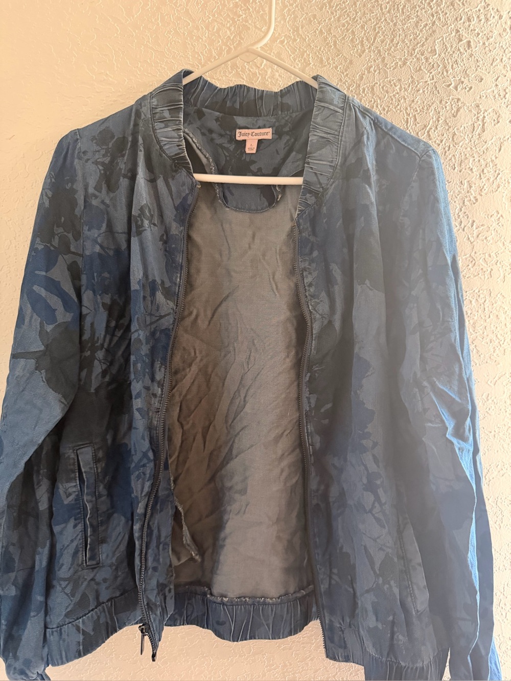 Juicy Couture Pink Label on Dark Blue Garment